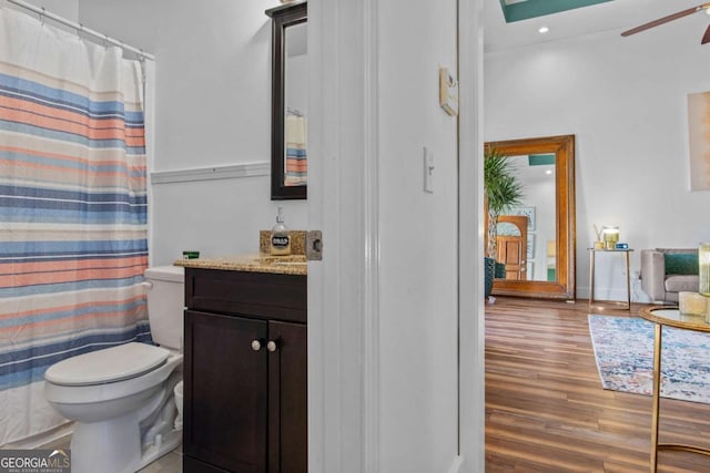 full bath featuring a ceiling fan, toilet, a shower with curtain, wood finished floors, and vanity