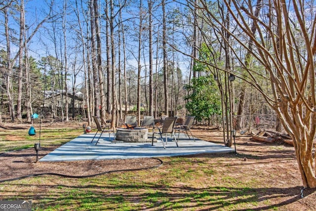 view of yard with an outdoor fire pit and a patio