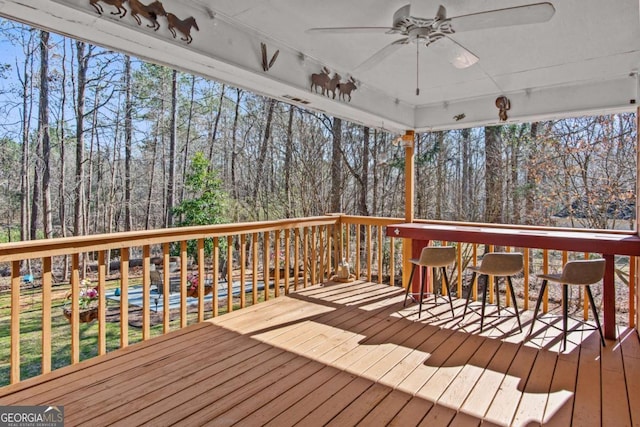 wooden deck featuring ceiling fan