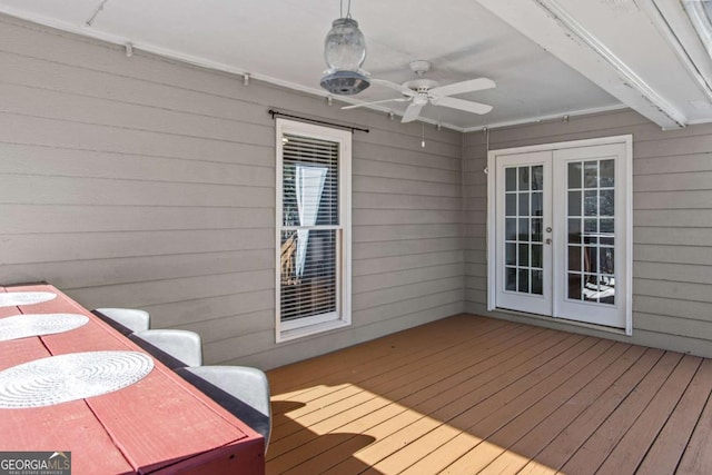 wooden terrace with ceiling fan and french doors