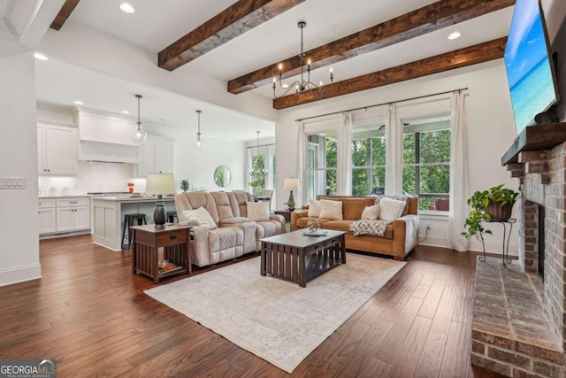 living room featuring dark wood-type flooring, a brick fireplace, and plenty of natural light