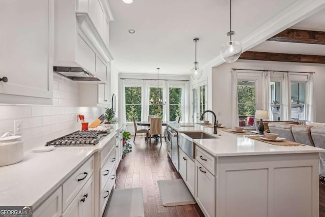 kitchen with premium range hood, a sink, white cabinetry, light countertops, and tasteful backsplash