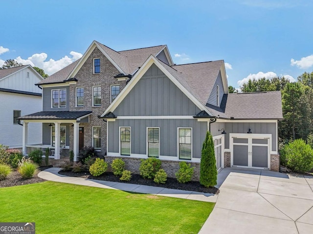 craftsman-style house featuring brick siding, a porch, an attached garage, board and batten siding, and a front yard