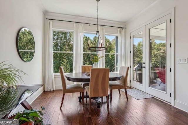 dining space featuring baseboards, dark wood finished floors, crown molding, and french doors