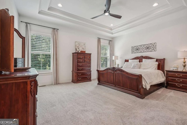 carpeted bedroom featuring a raised ceiling, a ceiling fan, and recessed lighting