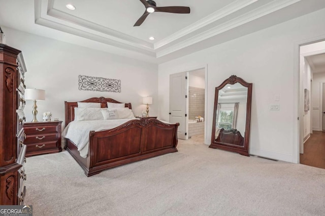 bedroom with light carpet, baseboards, a tray ceiling, and ornamental molding