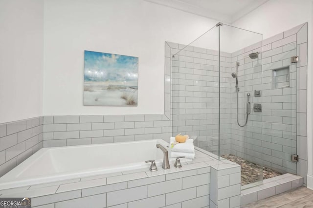 bathroom with a garden tub and a shower stall