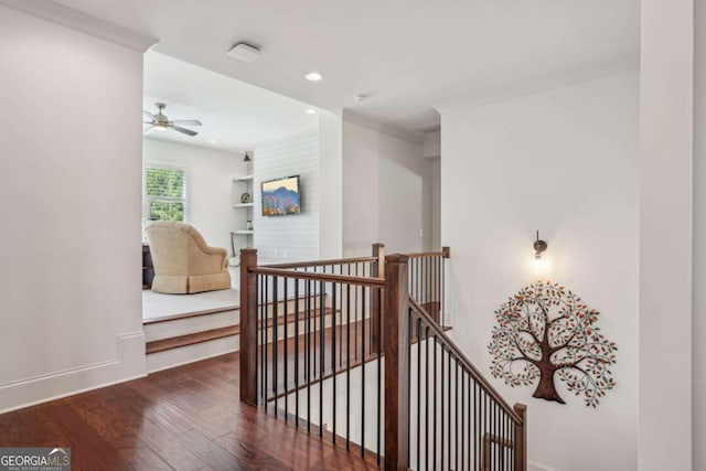 hallway featuring baseboards, hardwood / wood-style flooring, an upstairs landing, and recessed lighting