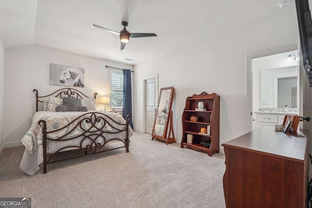 bedroom with ceiling fan, light colored carpet, visible vents, baseboards, and vaulted ceiling