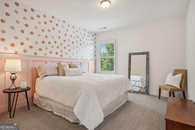 bedroom with carpet, visible vents, and wallpapered walls