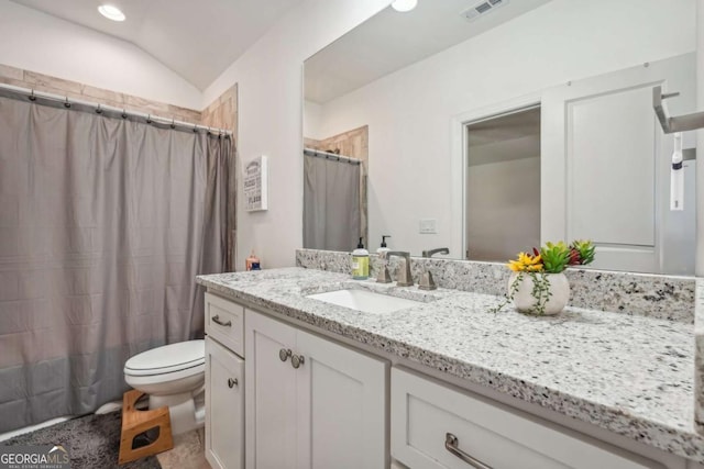 bathroom with visible vents, toilet, curtained shower, vaulted ceiling, and vanity