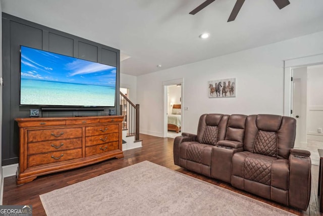 living room with dark wood-type flooring, a ceiling fan, recessed lighting, and stairs