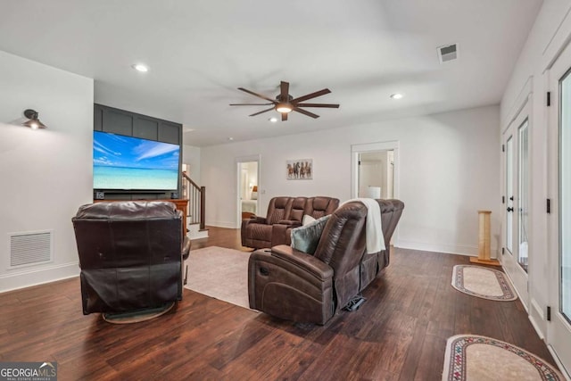 living area with dark wood-style floors, stairway, visible vents, and recessed lighting