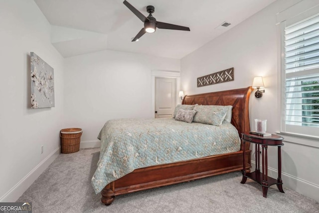 bedroom featuring visible vents, a ceiling fan, carpet flooring, vaulted ceiling, and baseboards