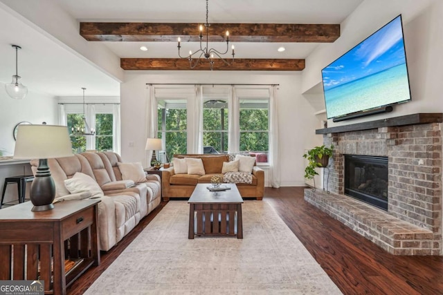 living area with baseboards, wood finished floors, a fireplace, a chandelier, and beam ceiling