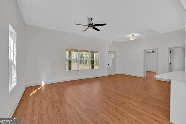 436 Tarpley Ave, Bowdon, GA 30108 - unfurnished living room featuring attic access, a ceiling fan, light wood-style flooring, and baseboards