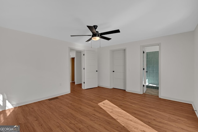 436 Tarpley Ave, Bowdon, GA 30108 - unfurnished bedroom with wood finished floors, baseboards, and ceiling fan