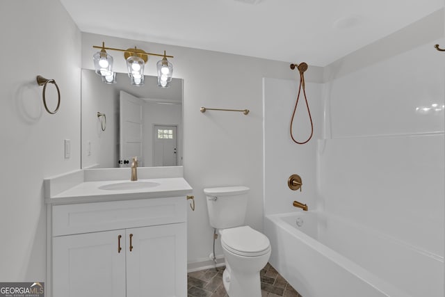 436 Tarpley Ave, Bowdon, GA 30108 - bathroom featuring vanity, toilet, washtub / shower combination, baseboards, and stone finish flooring