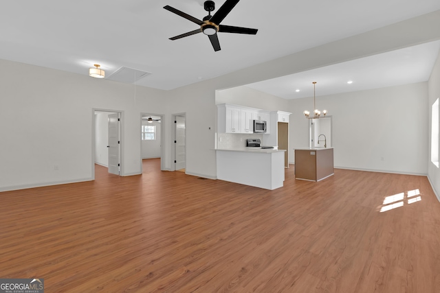 436 Tarpley Ave, Bowdon, GA 30108 - unfurnished living room featuring attic access, a ceiling fan, light wood-style floors, and recessed lighting