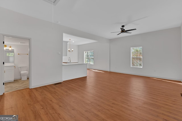436 Tarpley Ave, Bowdon, GA 30108 - unfurnished living room featuring attic access, light wood-type flooring, ceiling fan, and a sink