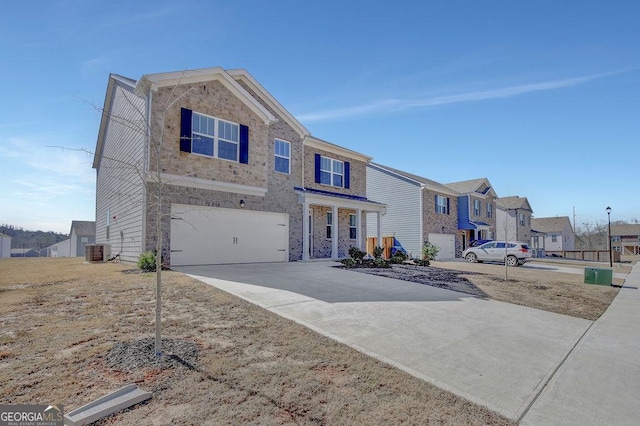 view of front of home featuring driveway, an attached garage, cooling unit, and a residential view