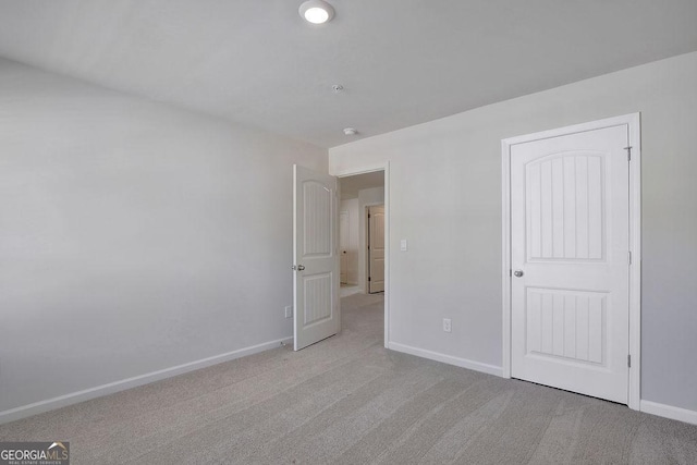 unfurnished bedroom featuring carpet and baseboards