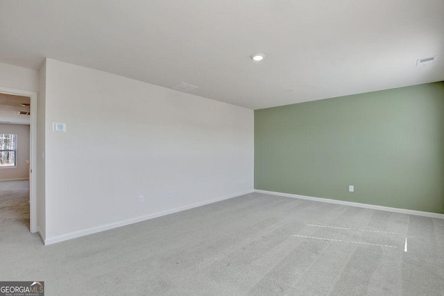 empty room with light carpet and baseboards