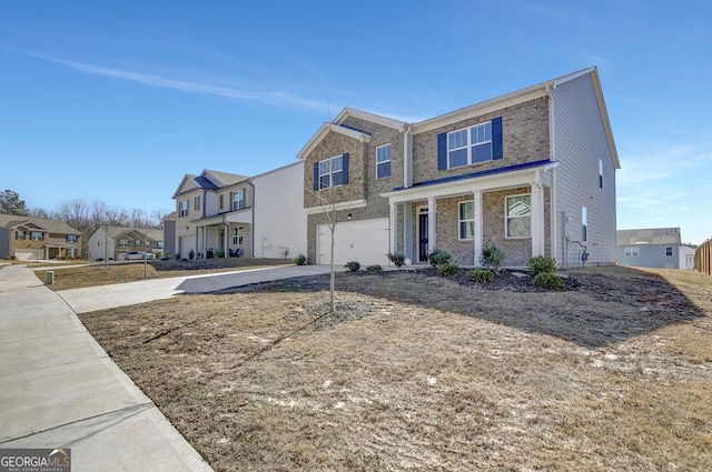 view of front facade with concrete driveway, brick siding, an attached garage, and a residential view