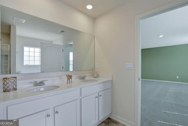 full bathroom with visible vents, a sink, and baseboards