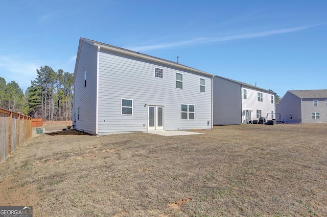 rear view of property with a patio area, fence, and a yard