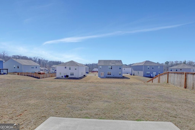 view of yard with a residential view and fence