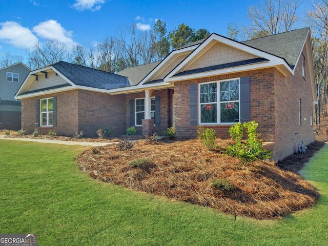 ranch-style house with brick siding and a front yard