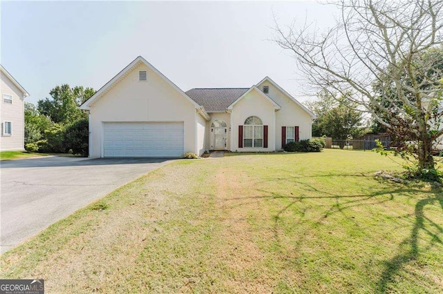 single story home with an attached garage, fence, driveway, stucco siding, and a front yard