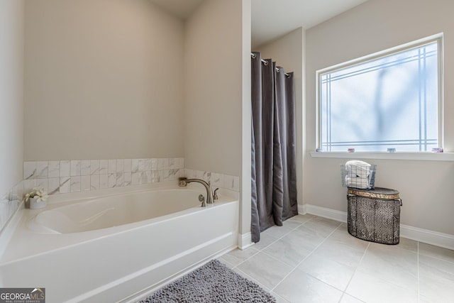 full bath with a garden tub, tile patterned flooring, baseboards, and a shower with shower curtain