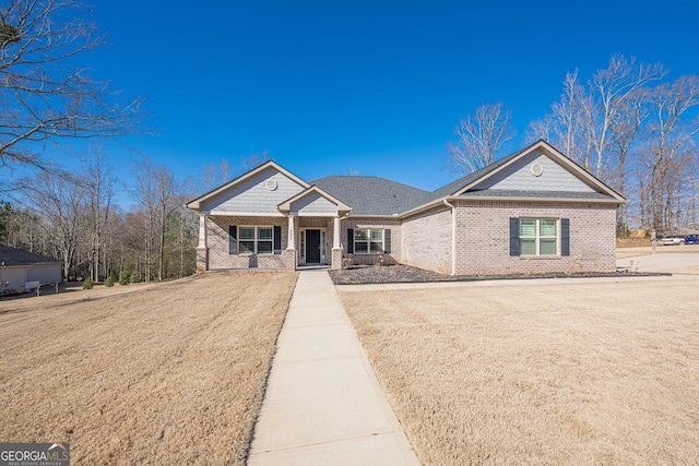 view of front of property featuring brick siding and a front lawn