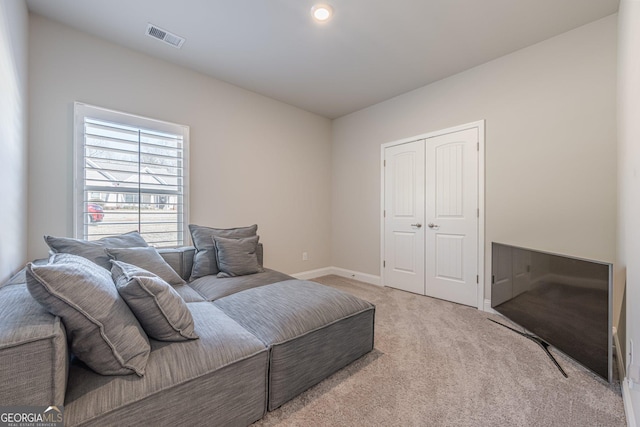 bedroom with a closet, visible vents, baseboards, and carpet flooring