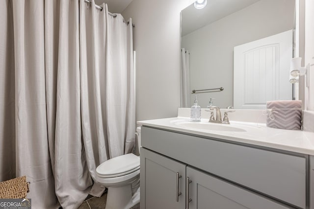 bathroom featuring vanity and toilet