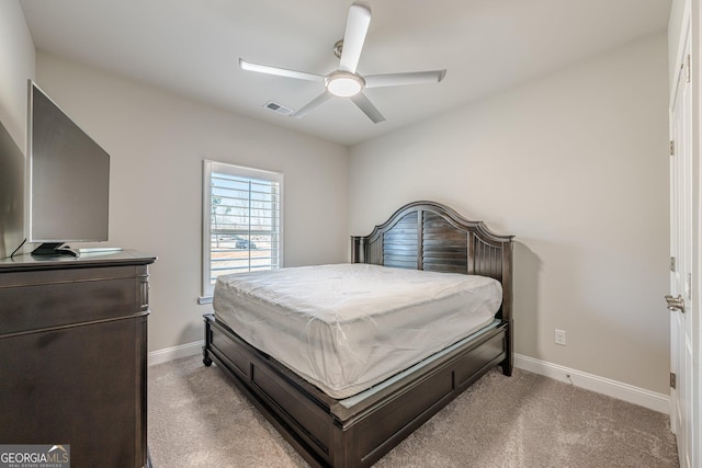 bedroom with baseboards, visible vents, and light colored carpet