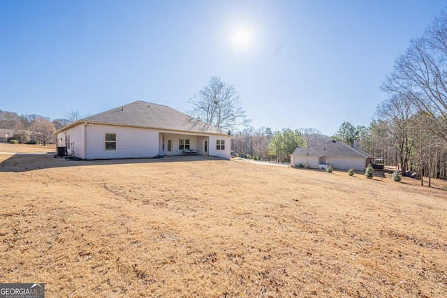 back of property with roof with shingles