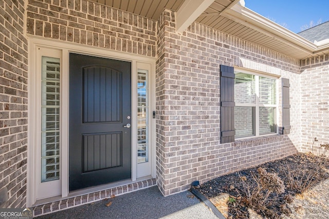 entrance to property with brick siding