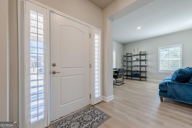 entrance foyer with light wood-style flooring and baseboards