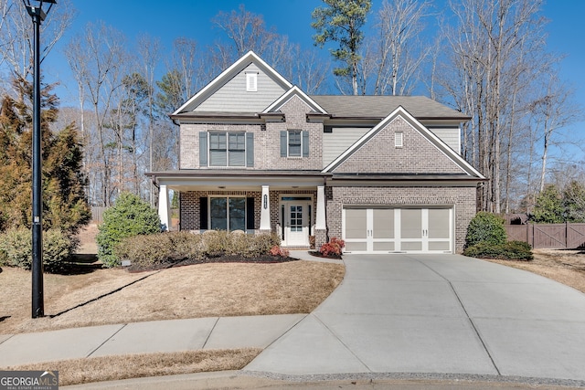 craftsman-style house featuring driveway, a garage, fence, a porch, and brick siding