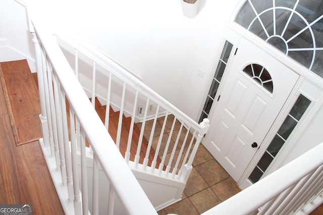 stairs with tile patterned floors