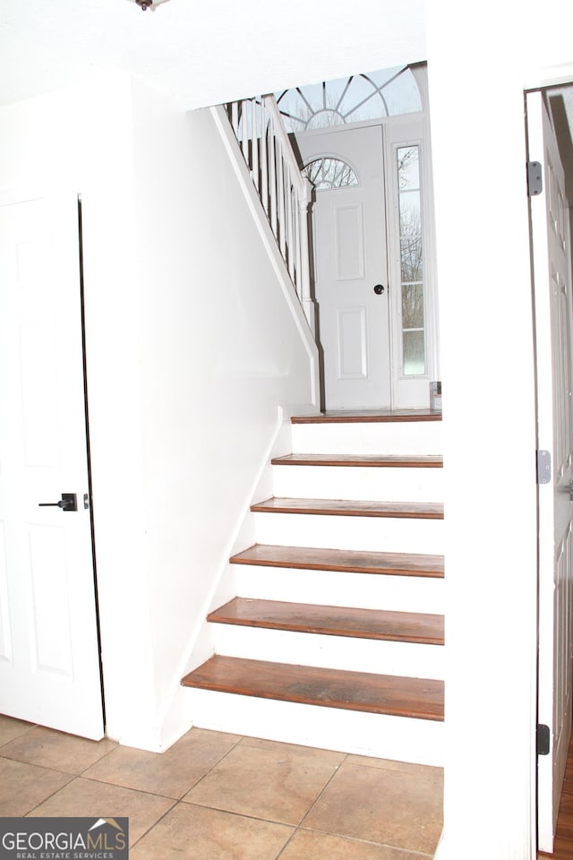 stairway with tile patterned flooring