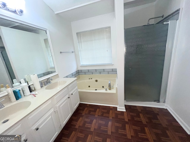 full bathroom with double vanity, a tub with jets, a stall shower, and a sink