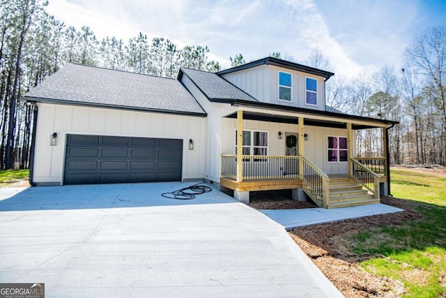 modern farmhouse featuring a shingled roof, concrete driveway, an attached garage, covered porch, and board and batten siding