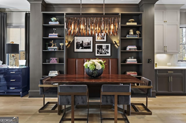 kitchen with light wood-type flooring, appliances with stainless steel finishes, open shelves, and light countertops