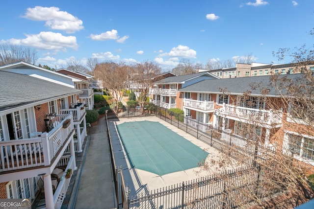 view of pool with fence and a residential view