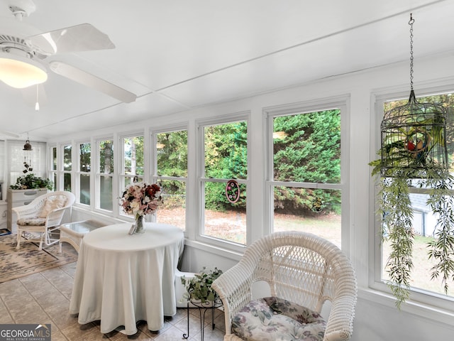 sunroom featuring ceiling fan