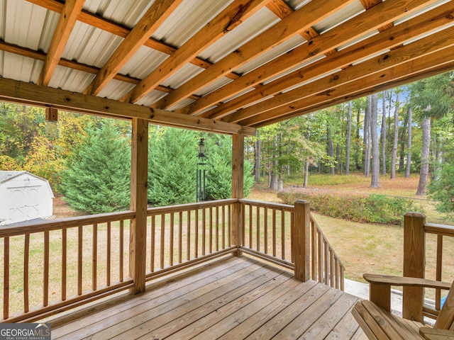 wooden deck featuring an outbuilding and a storage shed